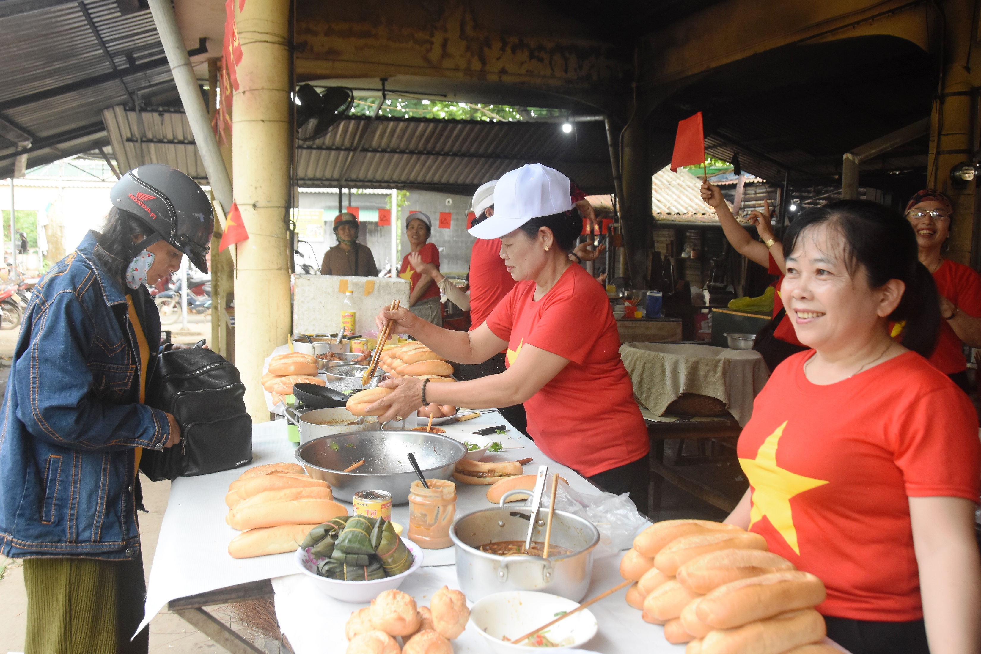 Hàng trăm tiểu thương chợ Lai Phước mặc áo đỏ sao vàng mừng ngày hội lớn của đất nước
